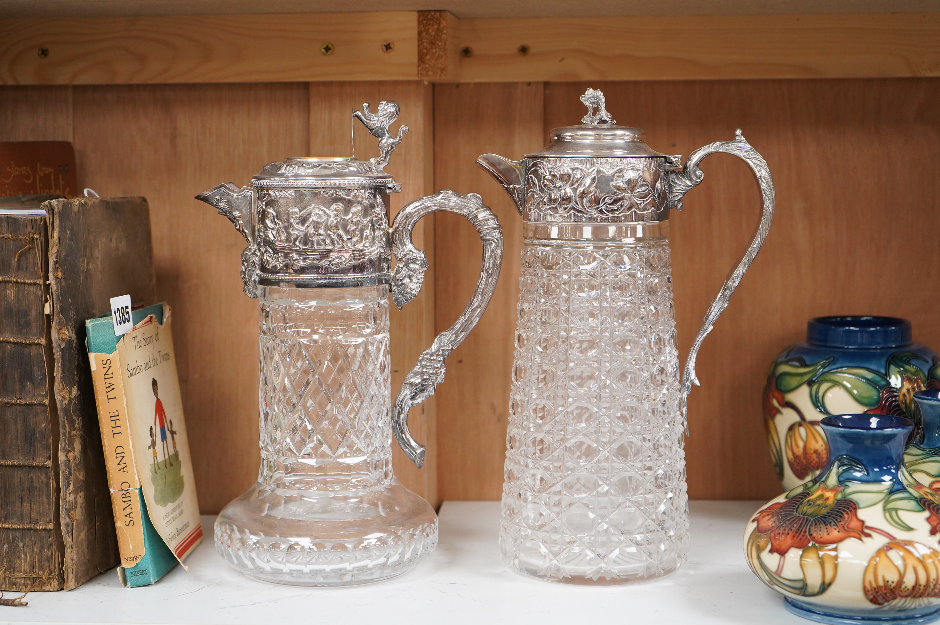 A silver plate mounted glass lemonade jug and a similar claret jug, largest 29cm high